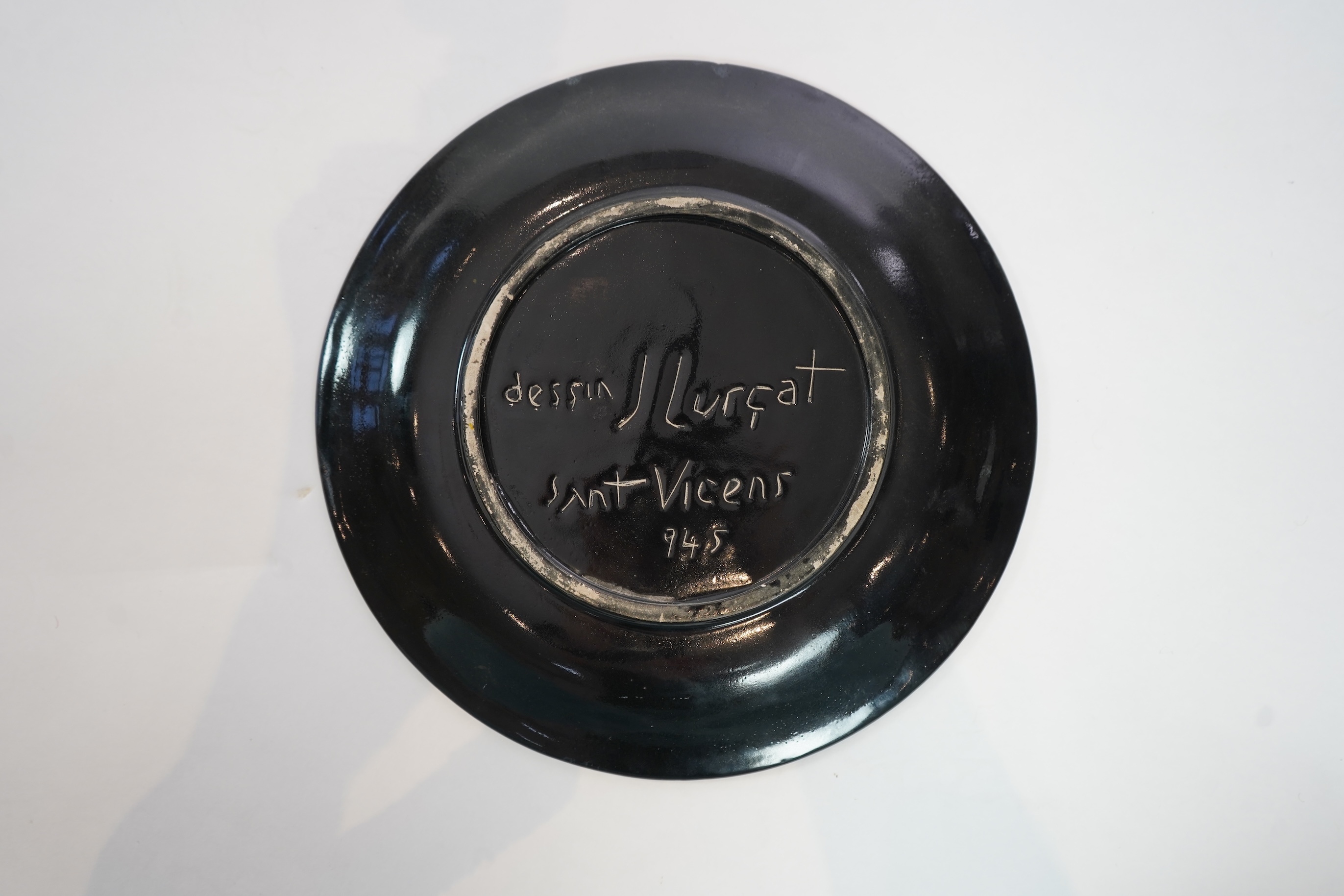 Jean Lurçat (1892-1966): An ochre and black glazed earthenware plate, decorated with a stylised central figure